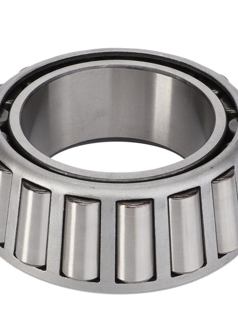 Close-up view of the AGCO | Taper Roller Bearing - CH1P-5419, showcasing its metallic finish with conical rollers arranged in a circle inside a cylindrical outer ring, adept at handling both radial loads and thrust loads.