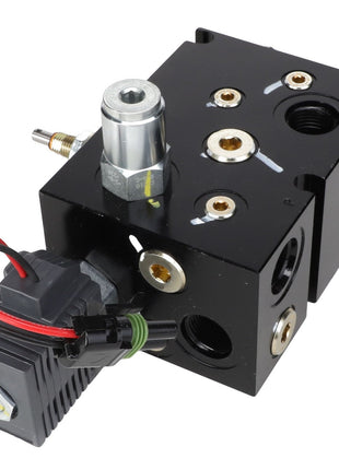 A black AGCO control valve block, model AG132504, featuring multiple ports and attached electrical wiring. No current product description information is available.