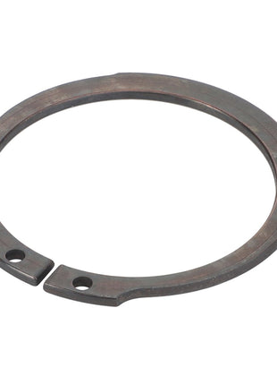 A close-up of the AGCO LOCK WASHER - F743300020470, featuring two precision-cut holes at each end, meticulously designed for securing components on a shaft or within a bore.