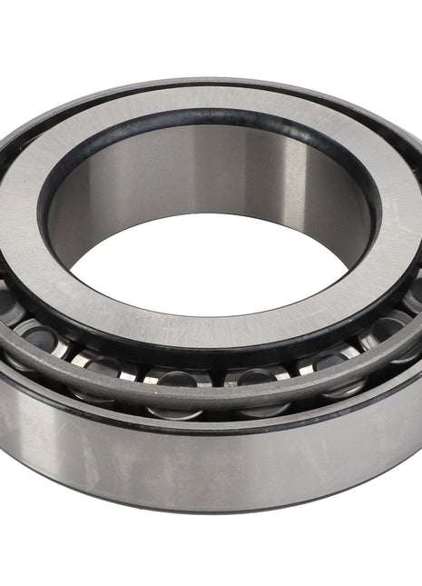 The AGCO BEARING ASSY - D41669400 is a steel cylindrical roller bearing with an inner and outer ring, featuring precisely spaced rollers designed to reduce friction efficiently.