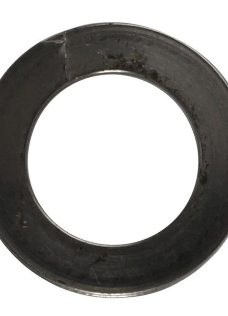 A close-up photo of the AGCO | Washer - 794339, a metal washer from the AGCO brand featuring a central hole and a slightly rough surface with visible smudges and imperfections. No current product description available for this specific item.