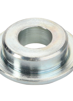 The AGCO | Spacer - Acw2402680 is a metallic washer with a wide base, a central hole, and a slightly raised outer ring. No additional information is needed to convey the simplicity and functionality of this essential hardware piece.