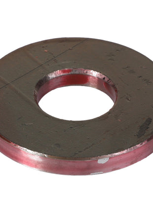 A flat, circular metal washer with a central hole and reddish edges, showing signs of wear and slight scratches. Product Name: AGCO Flat Washer - Acp0018820 by AGCO.