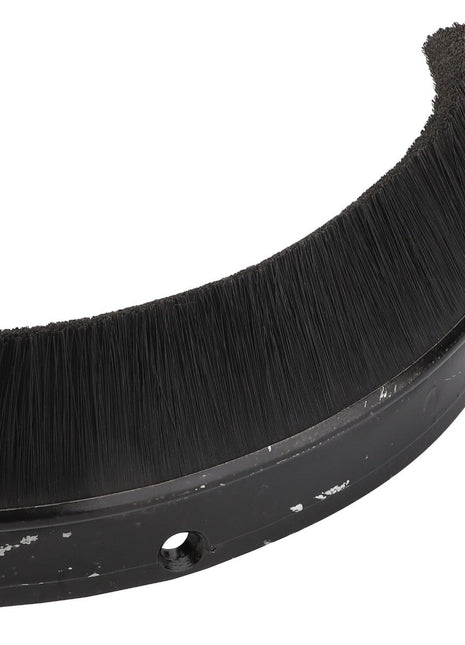 The AGCO Element - La320598850 is a curved black cleaning brush attachment featuring densely packed bristles along one edge and a small hole in the center of the base.