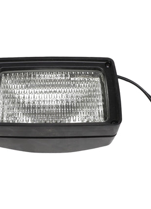 The AGCO | FLOOD LIGHT - AG213231 is a rectangular outdoor light fixture in black, featuring a transparent ridged front cover and two attached black wires. No current product description information available.