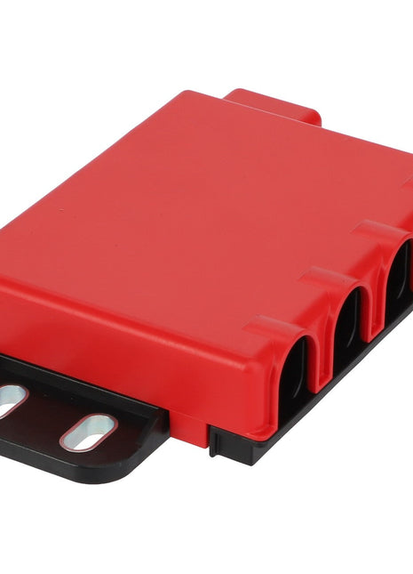 The AGCO Fuse Box - Acw4003450 is a red plastic electrical connector housing that features four cable entry slots, two mounting holes, and is mounted on a black base.