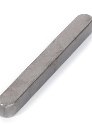 The AGCO | KEY - D43104100, a metal bar with rounded ends, is lying flat on a white surface. Further details are currently unavailable as no additional product description information is provided.