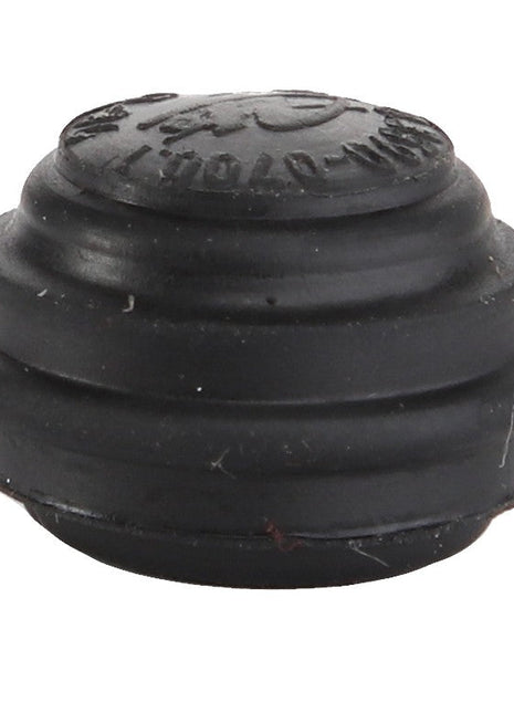 The AGCO | CAP - D45908600, a small, round black rubber device with ridges and embossed text on the top, comes without additional product information.