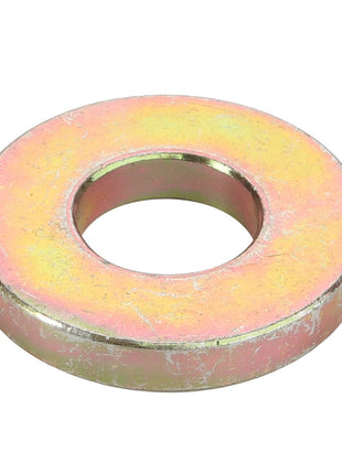 Close-up of the AGCO spacer, model D28280981, showcasing a central round hole with a slightly worn metal surface and a yellowish tint. No current product description information is available.