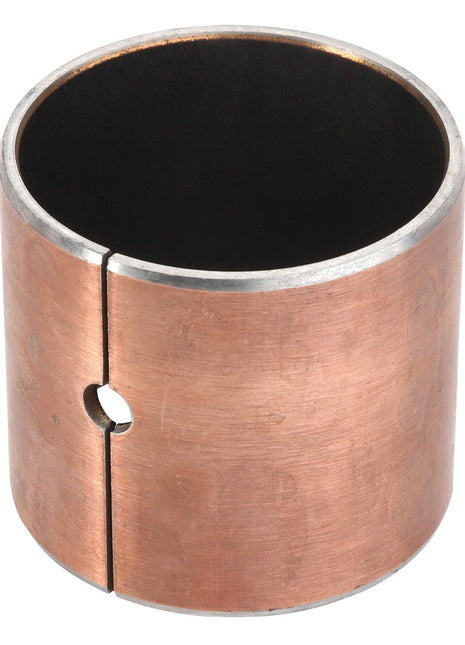 The AGCO Bush - Acp0287020 is a cylindrical metal bushing with a slit and a small circular hole on the side, featuring a copper-colored outer surface and a black inner surface.