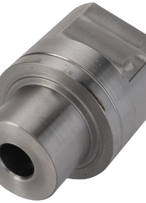 The AGCO Idler Shaft - Acw2337100 is a sleek, cylindrical metal component with a hollow center and a protruding end on one side. It features a flat, textured surface on the opposite end.