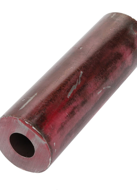 AGCO's Bush - Acp0017190 is a cylindrical metal pipe featuring a hollow center and a worn, reddish-brown surface.