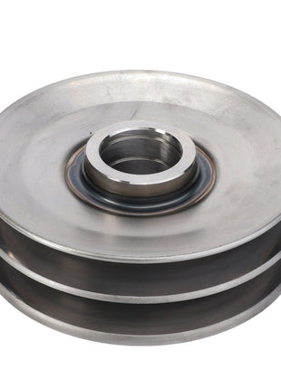 The AGCO Idler Pulley, Beater - D28384052, a metallic pulley with a central hole and two parallel grooves on its outer edge, is designed for maximum uptime in mechanical applications.