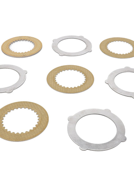 Close-up of AGCO's SET OF FINS - F712301020160, featuring seven meticulously arranged metallic and cardboard gaskets with varying inner and outer diameters on a pristine white background.