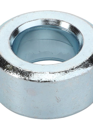 Introducing the AGCO Spacer - Acp0520550: A sleek, metallic, cylindrical spacer with a central hole and a surface boasting a shiny silver finish.