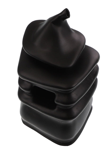 A stack of black, squarish, soft-looking shapes with a pointed top, resembling a sculptural object or a unique container. This is the AGCO GAITER - AL60006255 by AGCO. No current product description information is available.