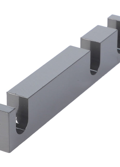 A sleek AGCO metallic gray Spacer - Acw0715410 cable management clip with three slots for neatly organizing wires.