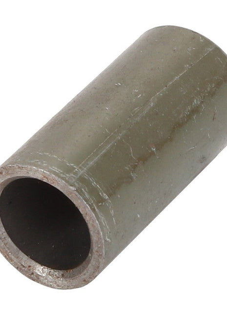 Close-up of the AGCO BUSH - D28981237 cylindrical metal pipe fitting, featuring a hollow center and a weathered exterior surface. No current product description available.