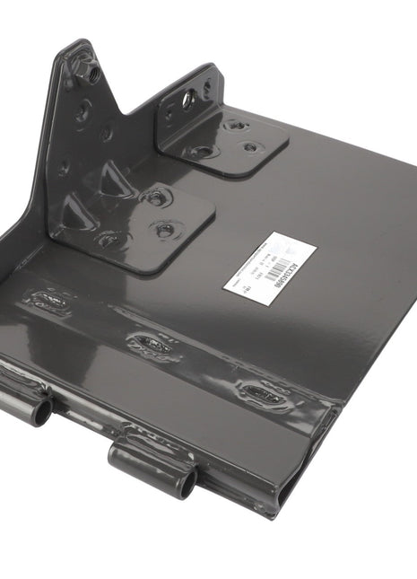 A close-up view of a gray, flat, metal bracket with mounting points and a barcode label. This item is the AGCO Right Hand Deflector - Acx3345890 from the brand AGCO.
