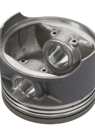 A close-up of the AGCO | PISTON - ATV3402-265 metal engine piston with precise detailing, featuring polished internal surfaces and piston rings around the bottom edge. Please note that no current product description information is available.