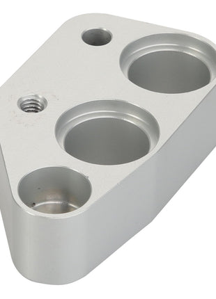 The AGCO Spacer - Acx2416060 from the brand AGCO is a sleek, metallic component with a geometric shape, featuring three circular indentations and one threaded hole.