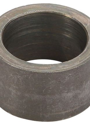 The AGCO SPACER - D28782757 is a cylindrical metal ring-shaped component with a rough, slightly tarnished surface. The interior is threaded, indicating it serves a mechanical purpose. Detailed product description information for this AGCO item is currently unavailable.