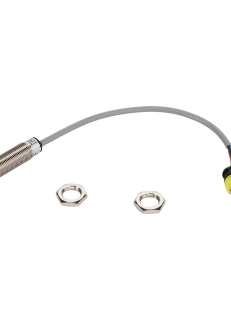 The AGCO Inductive Sensor - Acw0926390 is a cylindrical metal sensor featuring a blue tip. It is connected by a gray wire to a black and red connector, and comes with two hex nuts placed beside it.