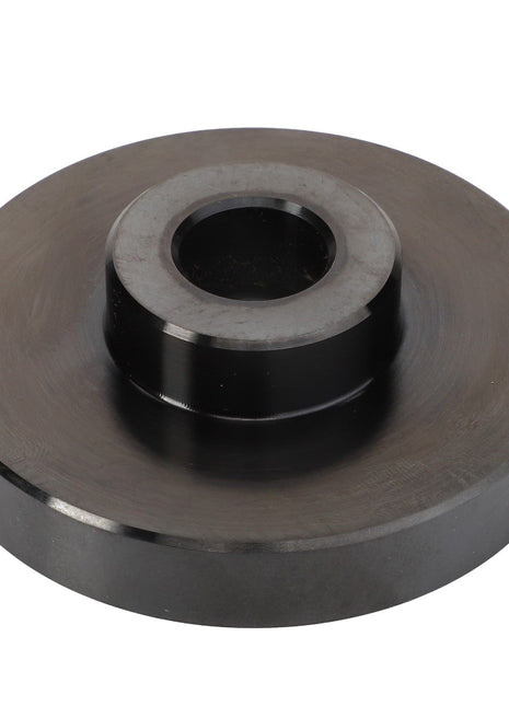 The AGCO | Tool - Acp0446480, a metal disc featuring a raised cylindrical center and a central hole, appears to be a specialized mechanical component. No current product description is available.