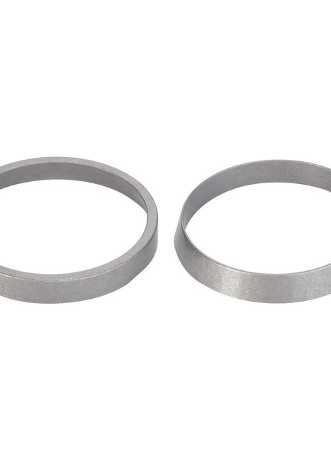 Two silver, circular metal components, one flat and one conical, are placed side by side on a white background. These components exemplify AGCO Parts Genuine quality, ensuring maximum uptime and peak efficiency for your machinery. Introducing the AGCO | Tightener, Beater Pulley - D42595900 from AGCO.