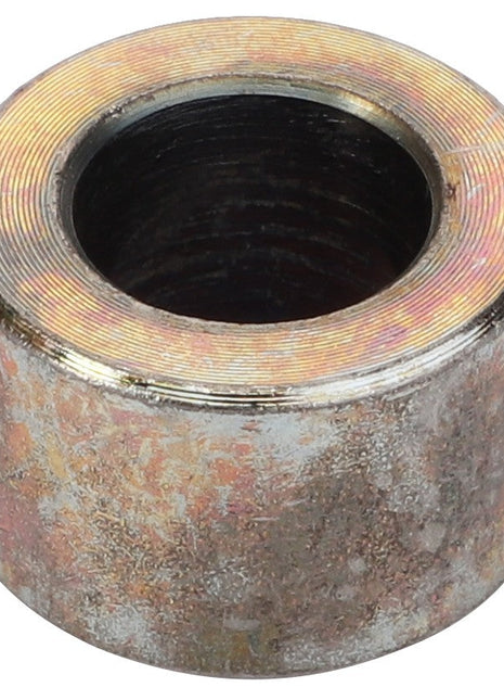 The AGCO Spacer Tube - Fel140180, a cylindrical metal object with a central hole, features a weathered or corroded surface. No current product description is available.