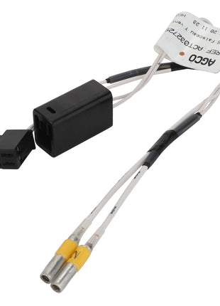 A close-up image of the AGCO | Harness - Act0027290 connector with attached wires and a small tag. The connector, featuring black and yellow ends, suggests intricate detail. No current product description available.