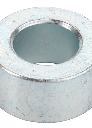The AGCO Spacer - Acp0313650 is a sleek, metallic cylindrical spacer featuring a precisely machined central hole.