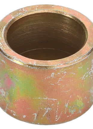 A cylindrical, metallic bushing with a weathered, multi-colored surface. Product Name: AGCO | Bush - Fel151081 by AGCO. No current product description available.