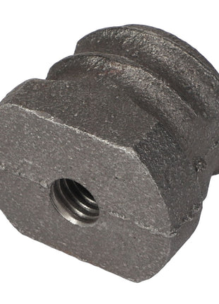 Close-up of an AGCO Spring Plug - Acp0025610, a gray metal component with a threaded hole, featuring a grooved surface and an irregular shape.
