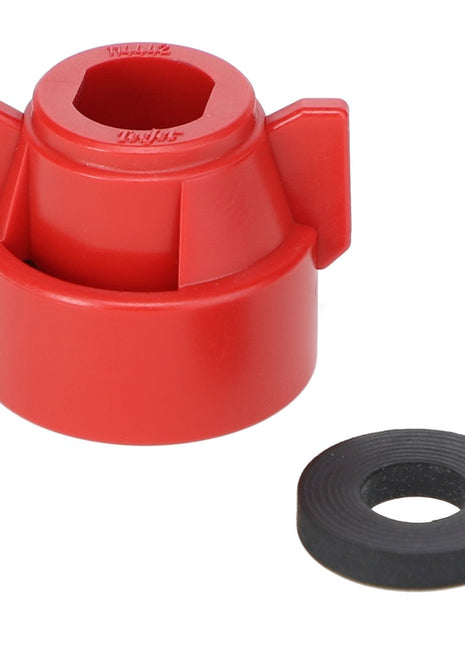 The AGCO | Quick TeeJet Cap, Red for Oval - ACP0484570 is a red plastic tool featuring a hexagonal opening and two protruding wings, along with a separate circular black rubber washer. If you have any ordering questions, please contact support for assistance.