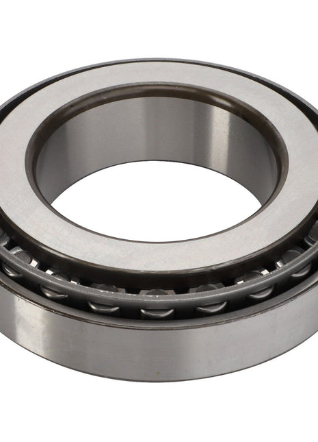 A close-up image of the AGCO | Taper Bearing - 3383714M1, showcasing its circular tapered roller bearing design with visible metal rollers and an inner and outer race, similar to those used in Massey Ferguson tractors.