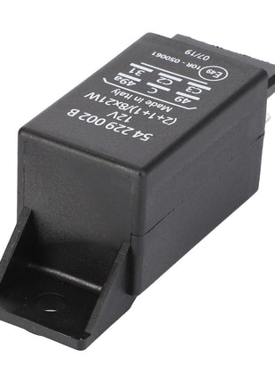 A black electrical relay with white technical specifications and symbols printed on its surface is shown. This relay, identified as AGCO | Relay, Blinker - X830030065000, is a product of the AGCO brand. It features metal prongs at one end and a mounting tab on the other, ensuring operating safety and reliability for Fendt Models.