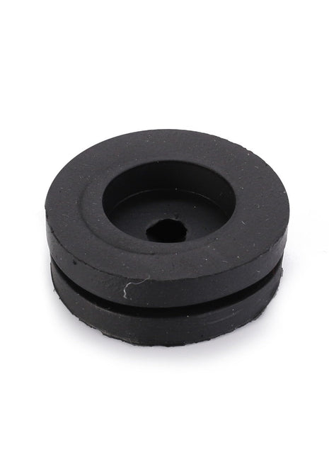 The AGCO Grommet (LA10397580) is a circular black rubber grommet featuring a central hole and a recessed groove around its edge, providing essential functionality.