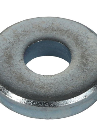 A close-up view of the AGCO | WASHER - AL5013177, a circular metal washer with a central hole, commonly used in conjunction with a bolt and nut to distribute load. No current product description information is available for this item from the brand AGCO.