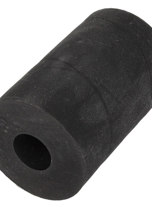 A black, cylindrical rubber AGCO | Bush - Acw1048320 with a central hollow shaft, resting upright on a white background. Please note that no current product description information is available at this time.