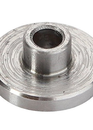 A close-up image captures an AGCO SPRING - D28382091, showcasing a small metallic washer with a distinct cylindrical protrusion at its center.