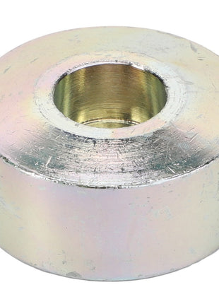 A seasoned AGCO Axle Stop, model Acw0837120, with a cylindrical shape featuring a central hole. The surface appears worn and slightly discolored, hinting at its enduring history.