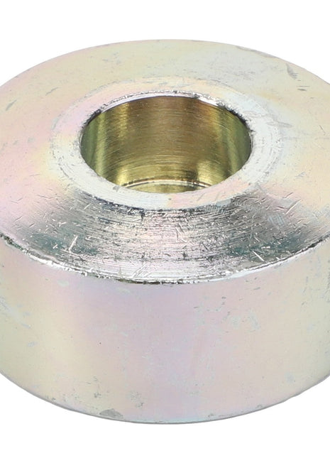 A seasoned AGCO Axle Stop, model Acw0837120, with a cylindrical shape featuring a central hole. The surface appears worn and slightly discolored, hinting at its enduring history.