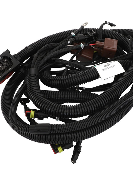 A coiled bundle of black electrical wiring harnesses with various connectors and labels attached. Product Name: AGCO | Harness - Acw102161B, Brand Name: AGCO.