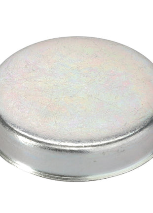 The AGCO Cover - F198300020390 is a circular metallic cap featuring a slightly raised, domed top, specifically designed to cover and protect the ends of cylindrical objects.
