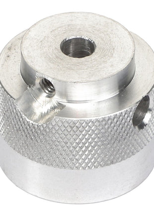 The AGCO | COUPLER - AG716993 is a cylindrical silver metal component with a knurled texture, featuring a central hole and two side holes for secure fastening.