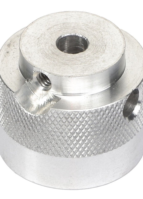 The AGCO | COUPLER - AG716993 is a cylindrical silver metal component with a knurled texture, featuring a central hole and two side holes for secure fastening.