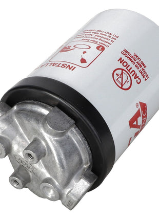 The AGCO Filter Head - Acw9147080, a cylindrical white oil filter from AGCO, features metallic fittings and cautionary text along with symbols that provide essential information on its surface.