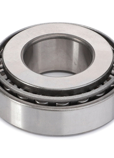 The AGCO Taper Roller Bearing - F199300020180, featuring a metallic outer ring and multiple cylindrical rollers, is ideal for managing thrust loads and is displayed on a plain white background.