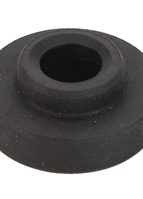 The AGCO Bush - Acp0336290, a black rubber grommet from the AGCO brand, is designed with a central hole to insulate and protect wires or cables passing through metal openings.